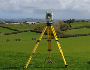 Tripod with total station in the middle of fields