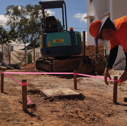 Pink survey flagging being placed on the job site.