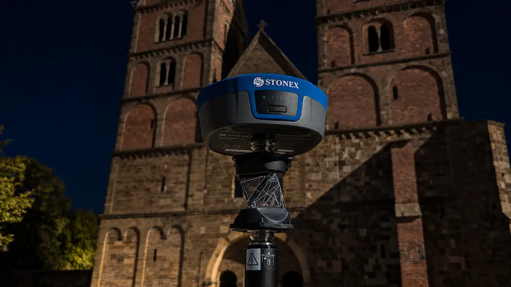 GNSS rover on a survey pole connected to NTRIP corrections at a land surveying jobsite